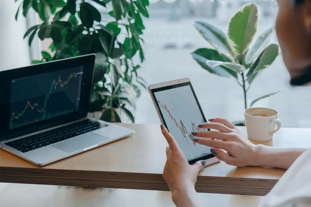 A woman reviewing a financial graph report on a digital tablet, representing modern accounting outsourcing services.